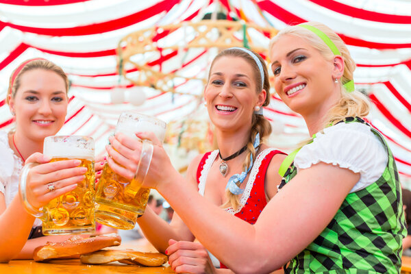 Friends drinking Bavarian beer at Oktoberfest