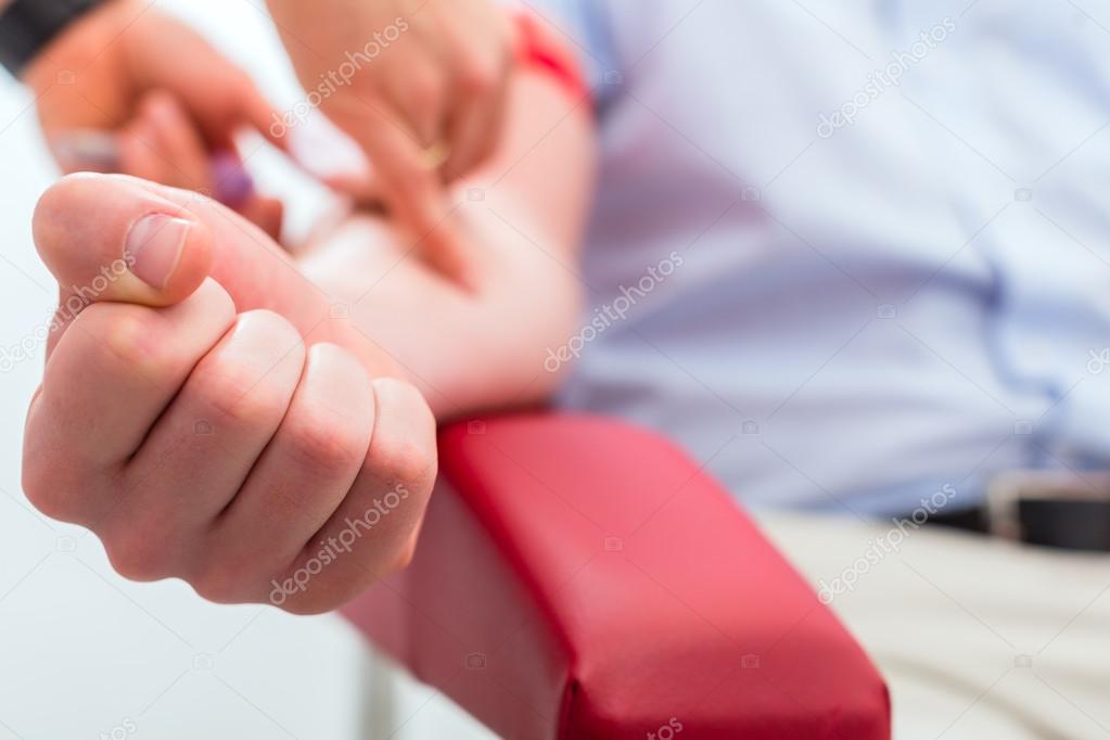 Doctor taking blood sample