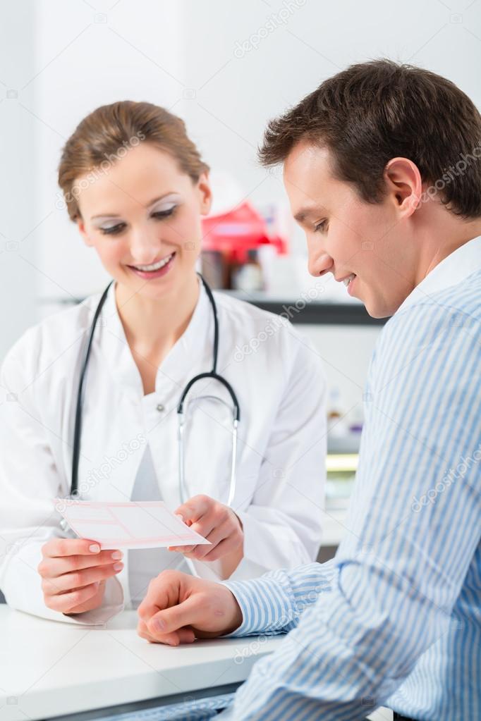 Doctor with patient in clinic consulting 