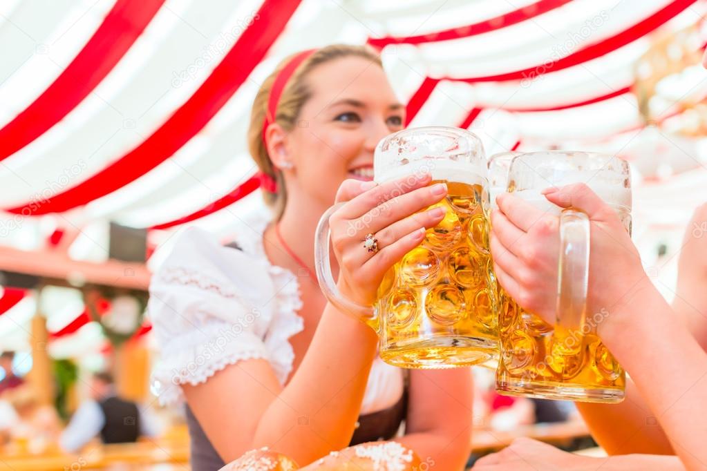 Friends drinking Bavarian beer at Oktoberfest