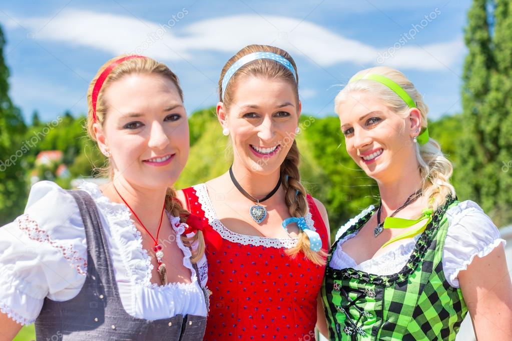 Friends visiting Bavarian fair having fun