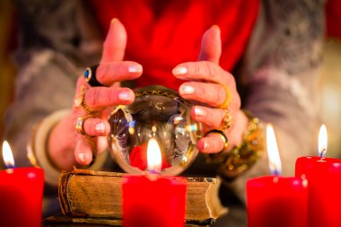 Soothsayer during esoteric session with Crystal ball