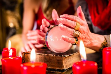 Fortuneteller during Seance with crystal ball clipart