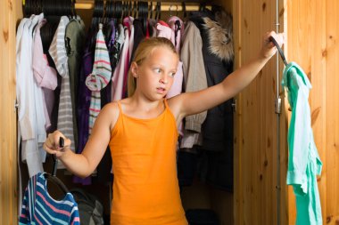 Family - child in front of her closet or wardrobe clipart