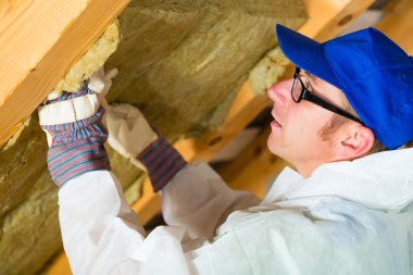 Worker setting thermal insulating material clipart