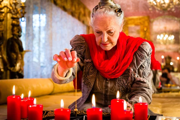 Wahrsagerin während einer Seance oder einer Sitzung mit Pendel — Stockfoto