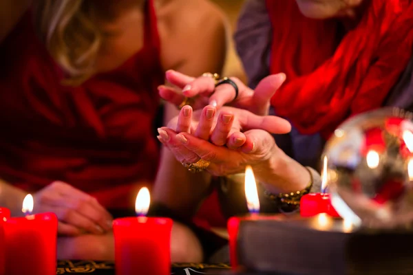 Soothsayer durante la sesión haciendo quiromancia — Foto de Stock