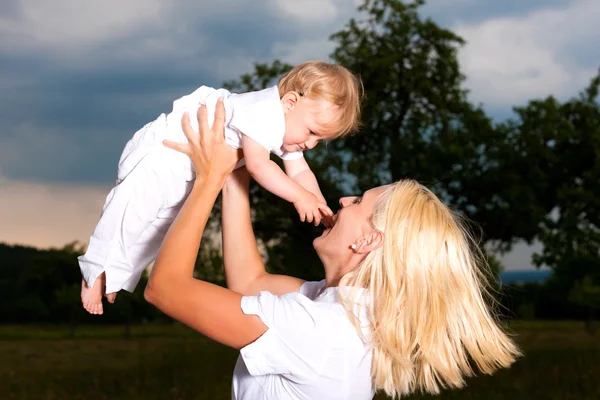 Madre che gioca con il bambino sul prato — Foto Stock