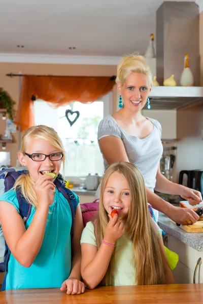 Familie - moeder ontbijt voor school maken — Stockfoto