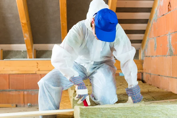 Worker cutting insulating material — Stock Photo, Image