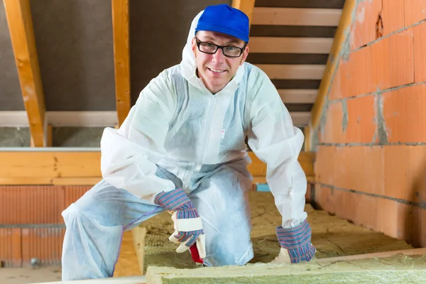 Worker cutting insulating material — Stock Photo, Image