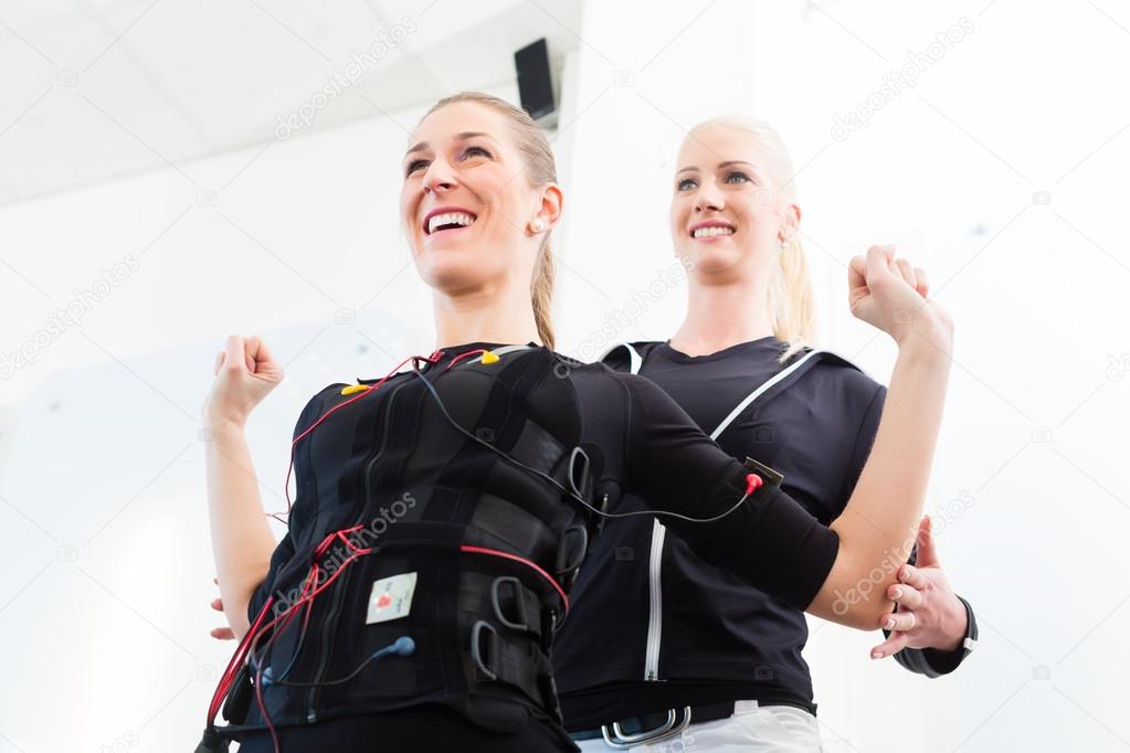 Man having ems training with personal trainer