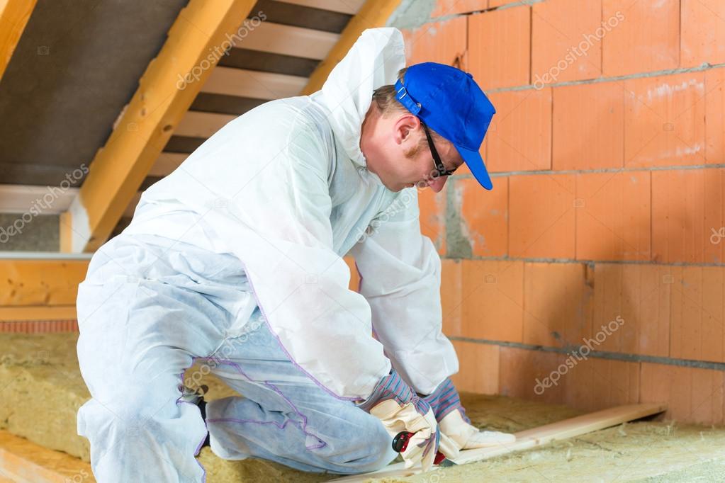 Worker cutting insulating material