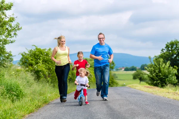 Happy family running for sport on street — Stock Photo, Image