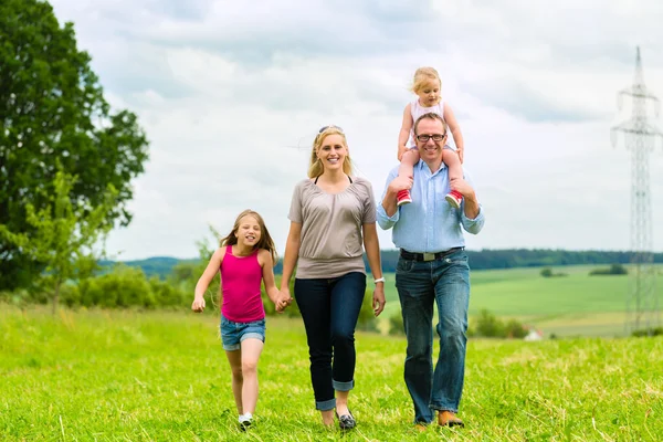 Happy Family walking in the meadow — Stock Photo, Image