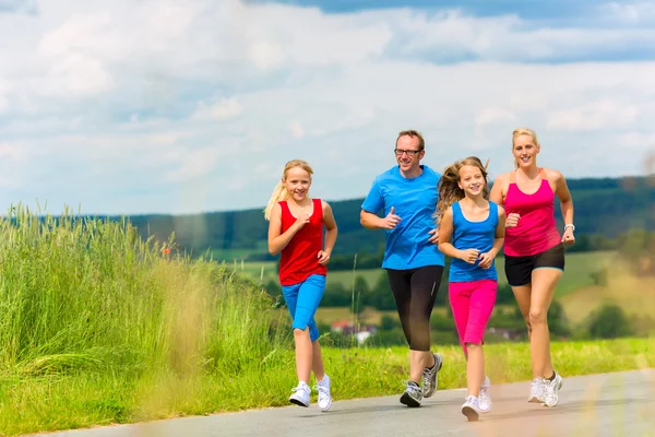 Happy Family is running outdoors in summer — Stock Photo, Image