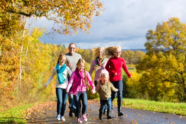 Family take a walk in autumn forest — Stock Photo, Image