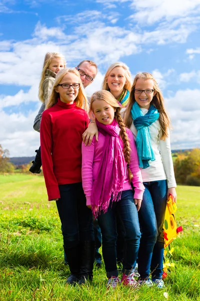 Family walking through the park in fall or autumn — Stock Photo, Image