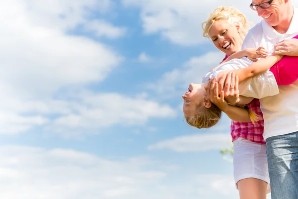 Family romping on field — Stock Photo, Image