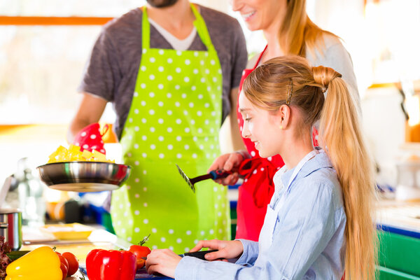 Family cooking in domestic kitchen healthy food