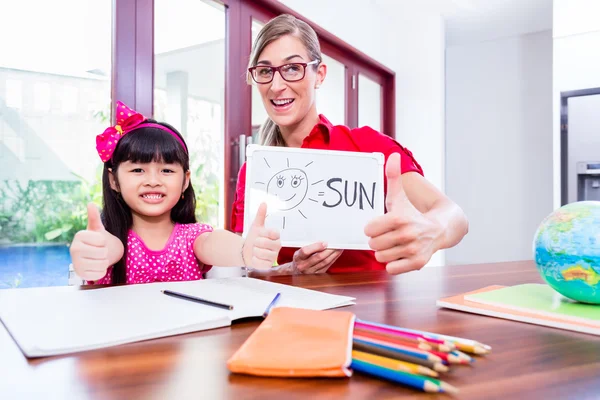 Teacher giving language lessons to Chinese child — Stock Photo, Image
