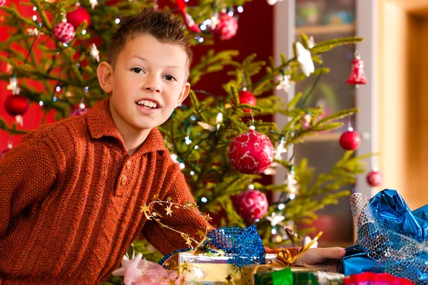 Christmas - little boy with Xmas present — Stock Photo, Image
