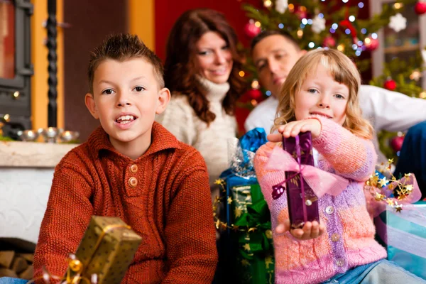 Christmas - family with gifts on Xmas Eve Royalty Free Stock Photos