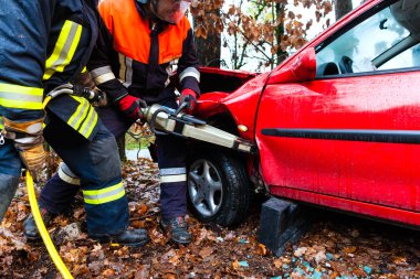 Accident - Fire brigade rescues Victim of a car clipart