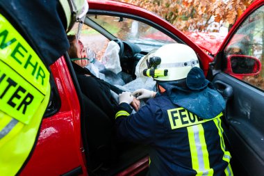 Accident - Fire brigade rescues Victim of a car crash clipart