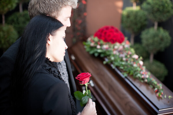 People at Funeral with coffin