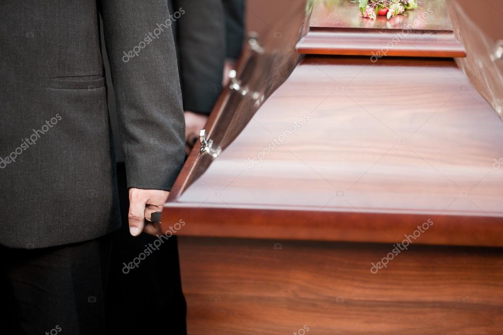 Coffin bearer carrying casket at funeral — Stock Photo © Kzenon 79652338