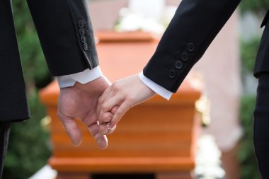 People at funeral consoling each other clipart