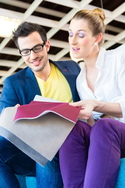 Couple picking couch seat cover in furniture store — Stock Photo, Image