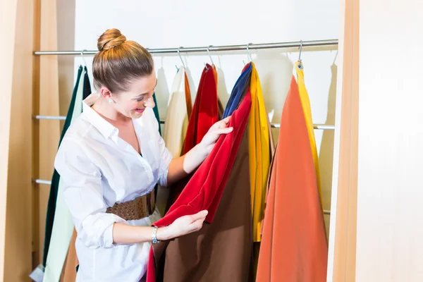 Woman picking seat cover in furniture store — Stock Photo, Image