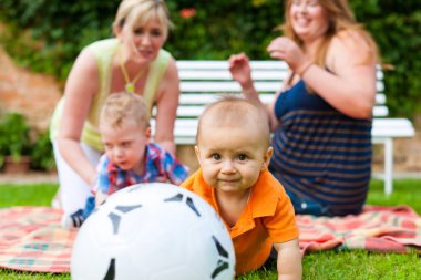 Mother and grandmother with children in a park