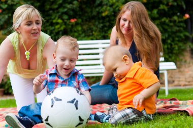 Mother and grandmother with children in a park