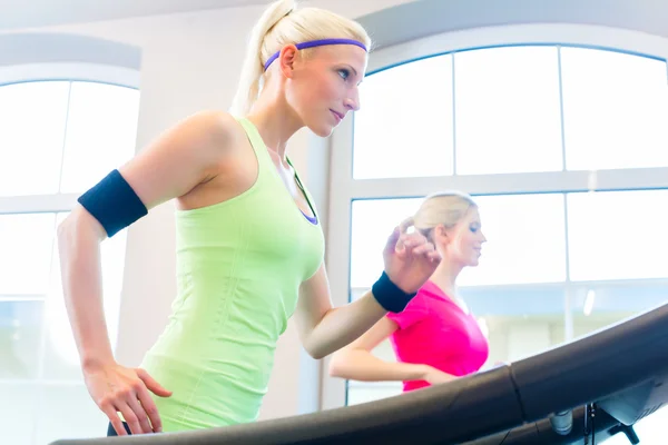 Жінки в спортзалі займаються спортом на біговій доріжці — стокове фото