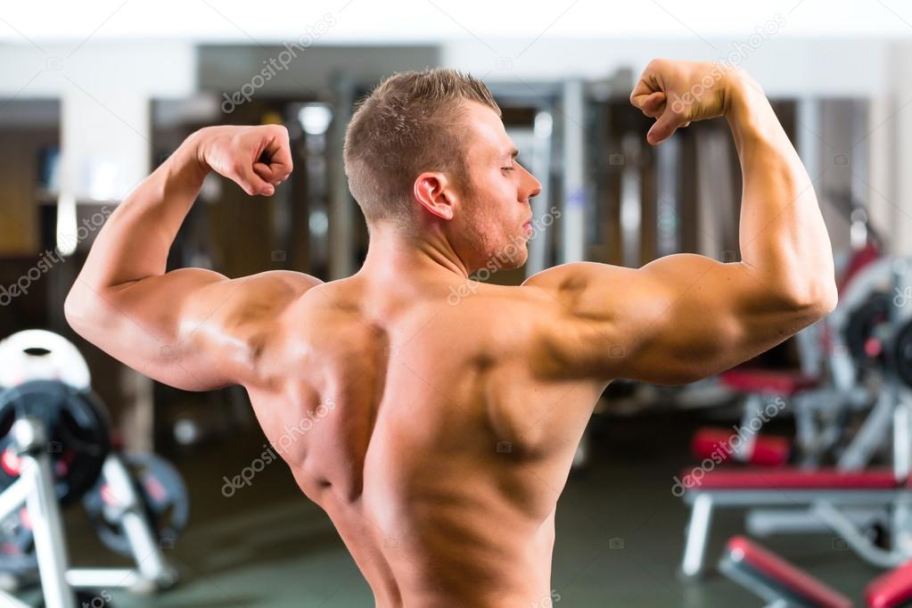 Bodybuilder posing in Gym