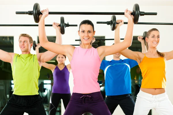 Gimnasio en grupo con barra de pesas — Foto de Stock