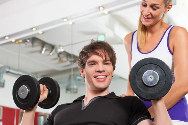 Paar uitoefenen in de sportschool met gewichten — Stockfoto