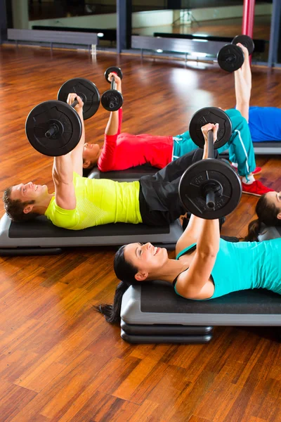 weight training in the gym with dumbbells