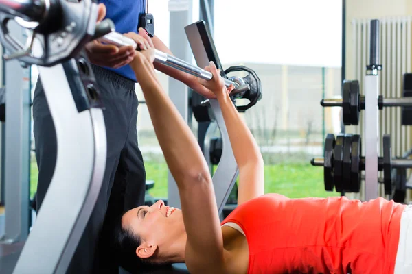 Woman and Personal Trainer in gym Royalty Free Stock Images