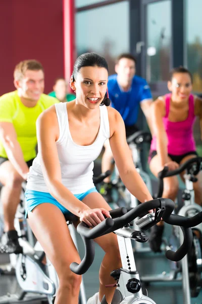 Young People Spinning in the fitness gym Stock Photo