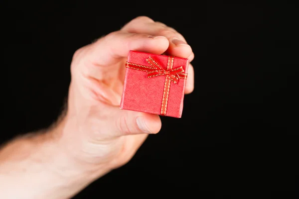 Hand showing red present box — Stock Photo, Image