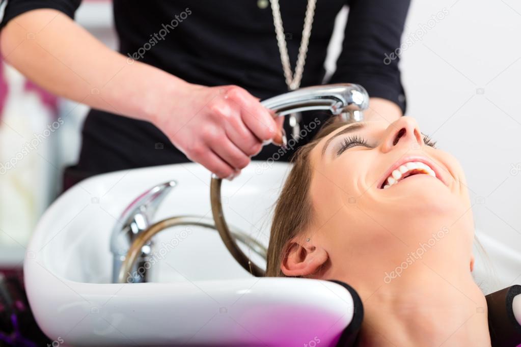 Woman at the hairdresser washing hair
