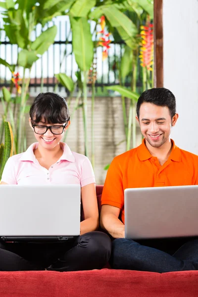 Aziatische paar op de Bank met een laptop — Stockfoto