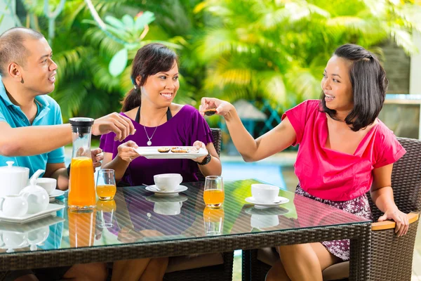 Asian friends having coffee on home porch — Stock Photo, Image
