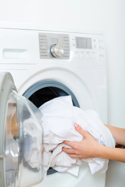 Housekeeper with washing machine — Stockfoto