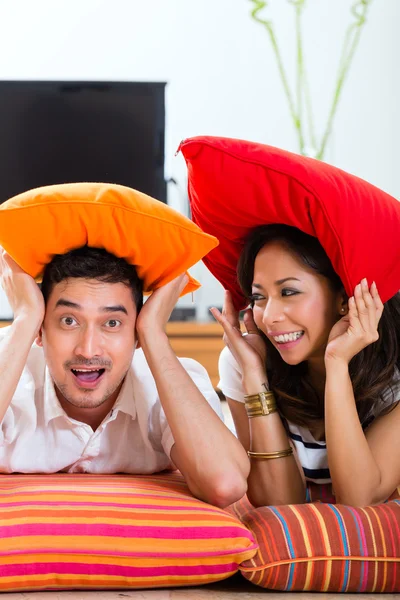 Asian couple at home in their living room — Stok fotoğraf