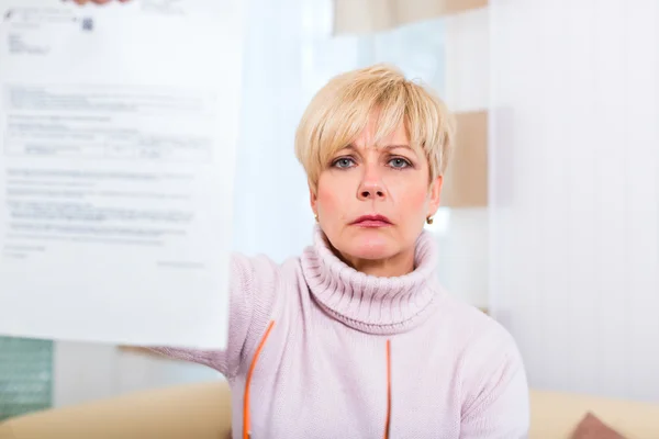 Senior at home receiving negative letter — Stock Photo, Image